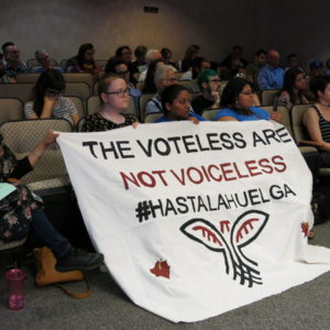 Supporters of immigrants' rights held a banner on Tuesday as Kalamazoo County commissioners discussed a resolution on family separations.
CREDIT SEHVILLA MAN / WMUK